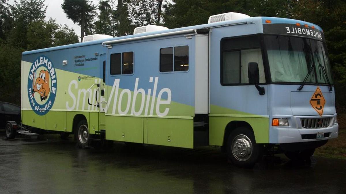 The SmileMobile, impervious to an all day drenching downpour, provided a dry dental clinic for patients at Vaughn Elementary last week. HUGH MCMILLAN/Special to the Gateway