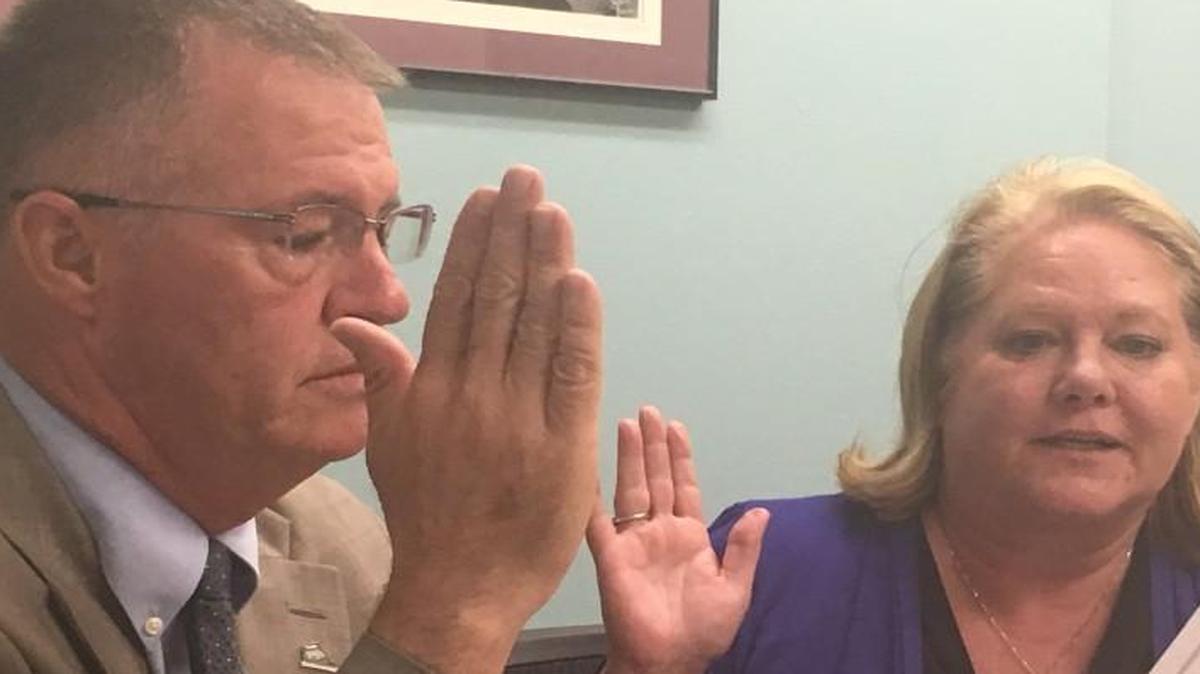 Thurston County Commissioner Bud Blake (left) and Auditor Mary Hall, who are members of the Thurston County Canvassing Board, certify the primary election on Tuesday.