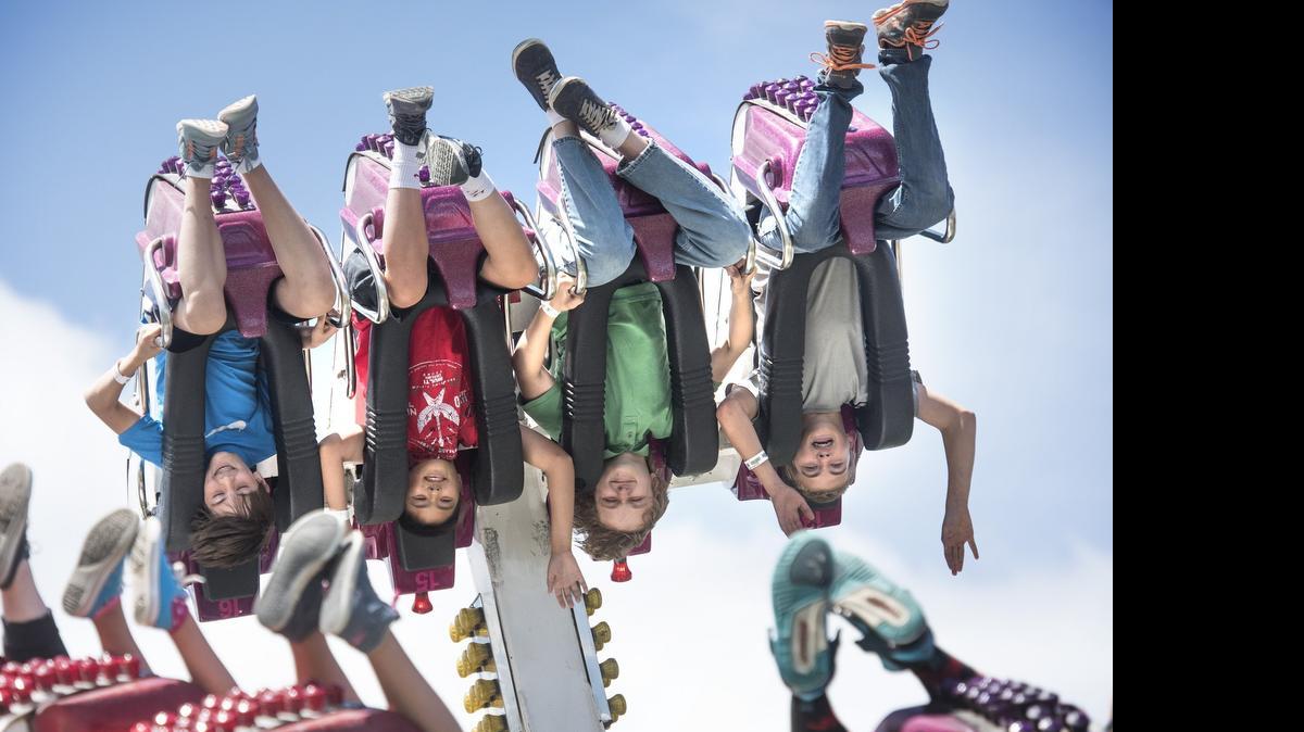 
Riders go upside down on the El Nino thrill ride during Funtastic Carnival's unlimited-ride wristband day at the Capital Lakefair in Olympia on Thursday.
