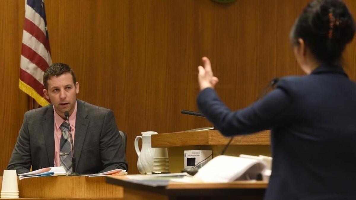 Olympia Police Officer Ryan Donald responds to defense attorney Sunni Ko’s during the trial of Andre Thompson and Bryson Chaplin on Monday in Thurston County Superior Court.