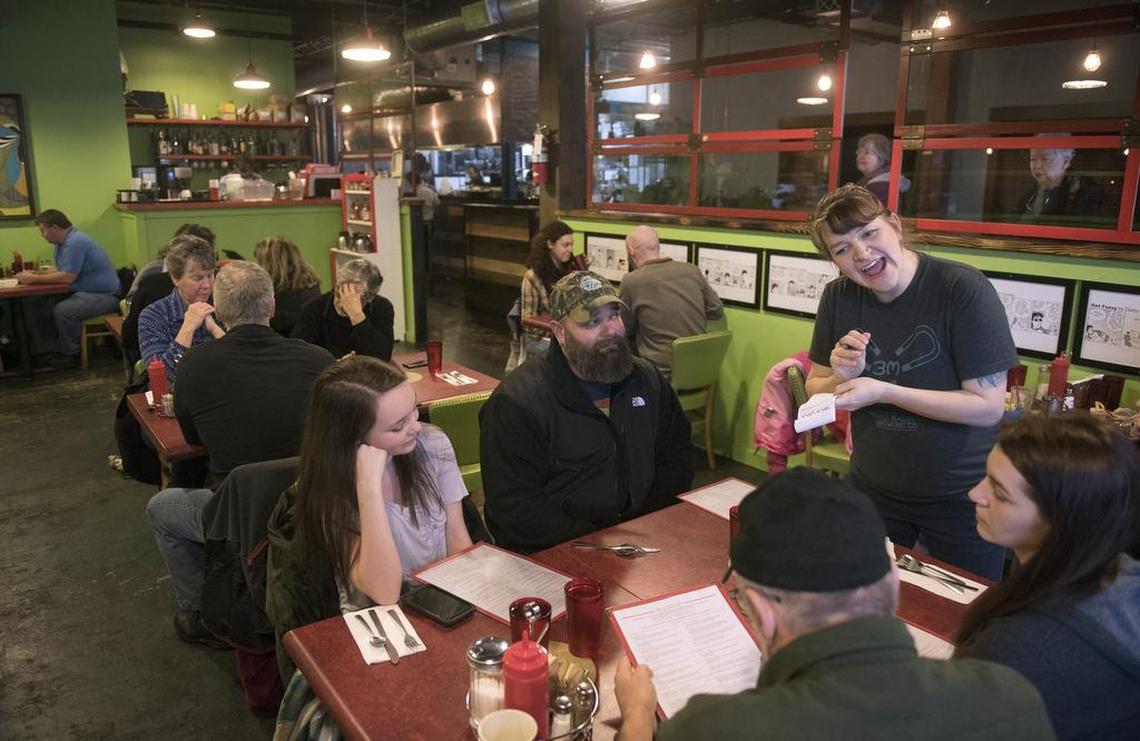 Co-owner Sara Reilly greets the a family during Saturday morning breakfast at Darby’s Restaurant in the Thurston First building in downtown Olympia.