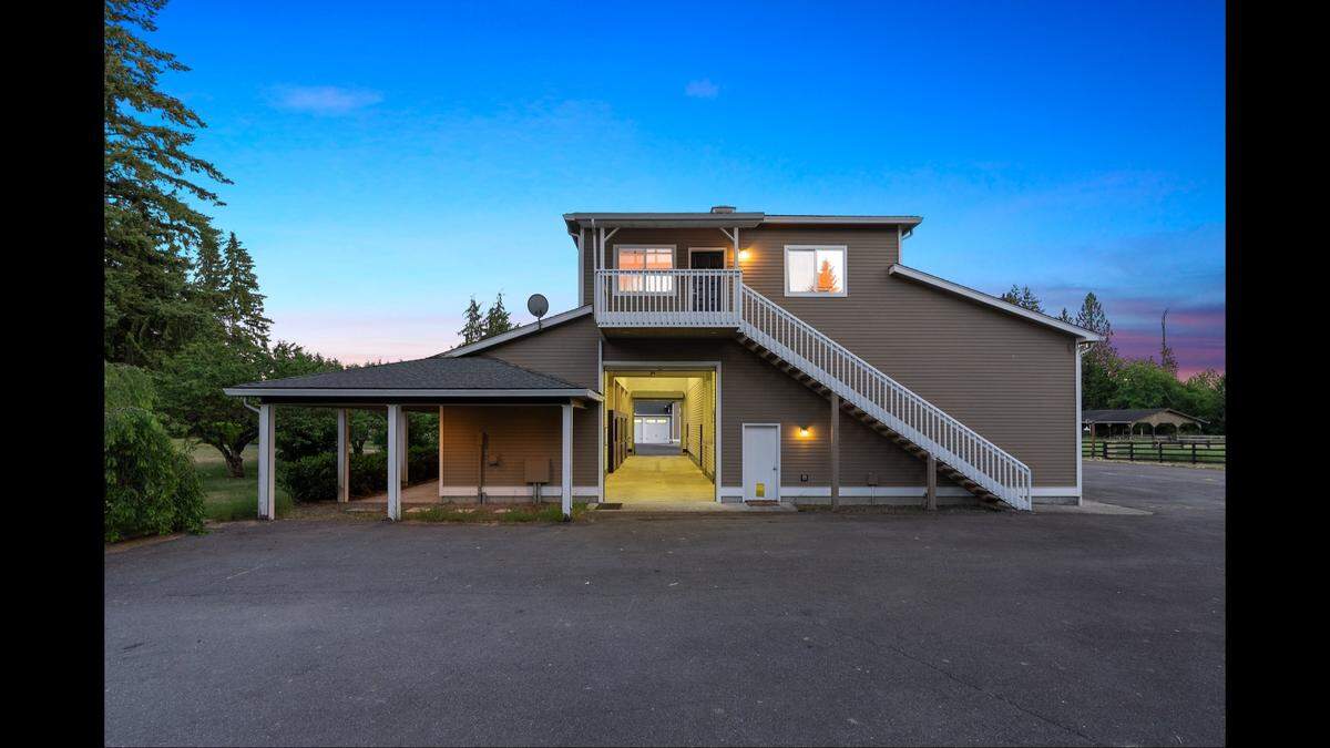 An estate on the market in Olympia has a three-stall barn with an apartment above, plus numerous other features.