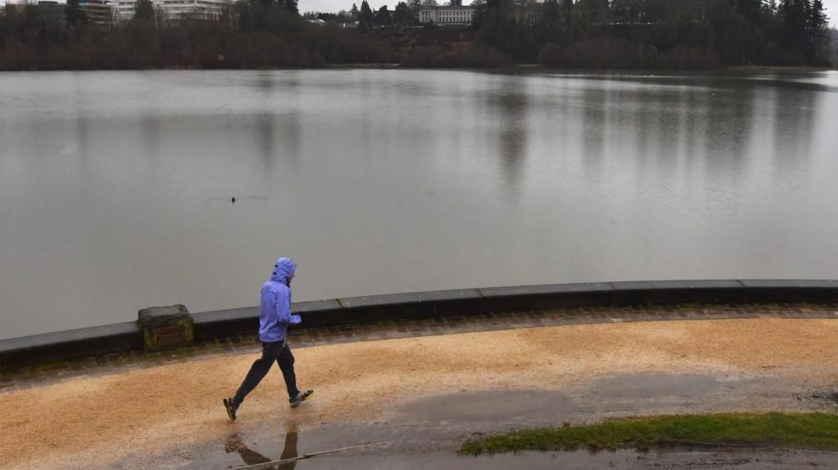 Having the Heritage Park running path almost to himself on a chilly and somewhat soggy Presidents Day on Feb. 20, a lone jogger makes his way along Olympia’s Capitol Lake.
