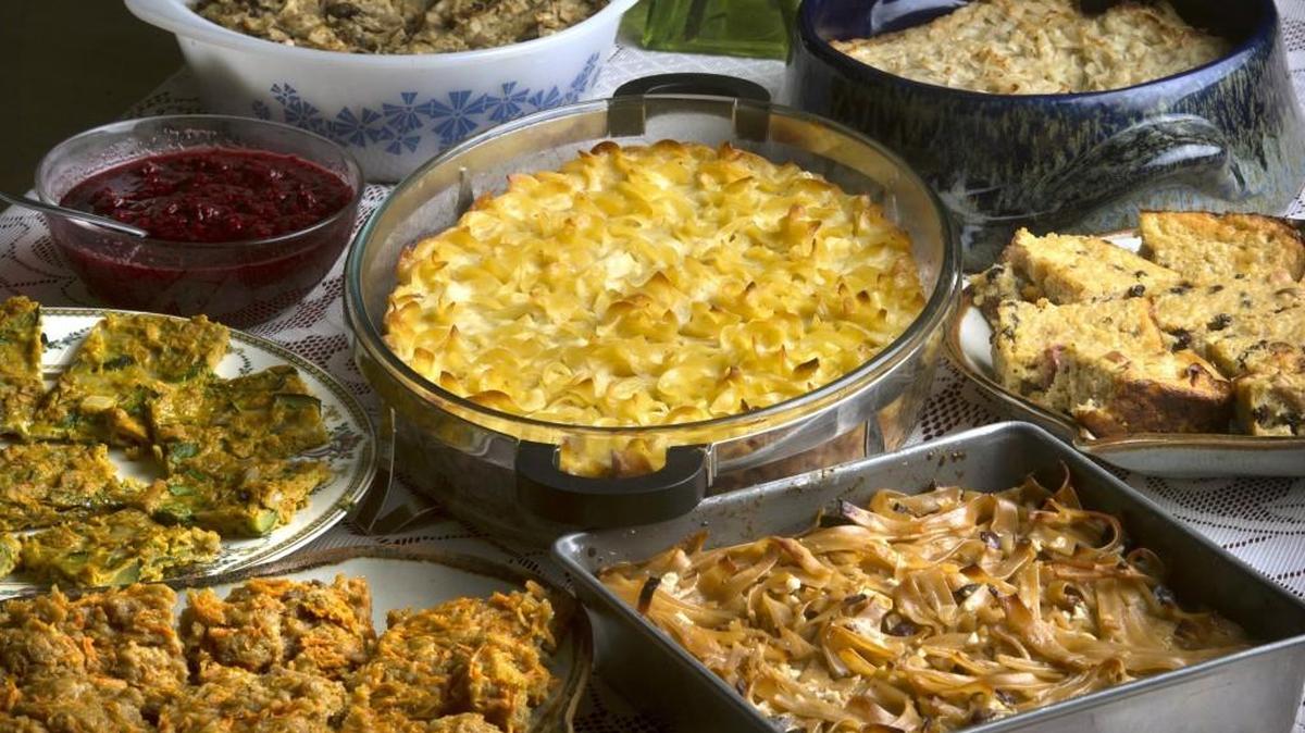 A mix of kugel dishes surround a traditonal lokshen kugel at the annual pre-Blintzapalooza preparation event at Temple Beth Hatfiloh in Olympia. Clockwise from upper left are farfel-vegetable kugel; Grandma Bearson’s potato kugel; sweet millet kugel with dried apricots, apples and currants; Barbara’s kugel with cranberries, almonds and figs; Ashkenazic carrot pudding kugel; savory sauteed veggie kugel. Blintzapalooza is Sunday.