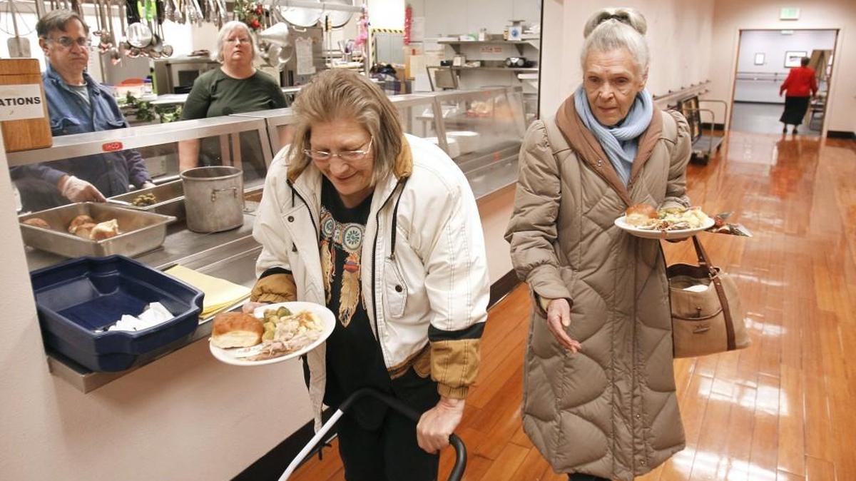Lorene Yarbrough (left) and Sharron Fairbanks arrive for lunch at the Olympia Senior Center in downtown Olympia on Dec. 19, 2014. A $33,500 donation will be used to reopen the Olympia Senior Center Community Dining Site for Friday meals starting in May.