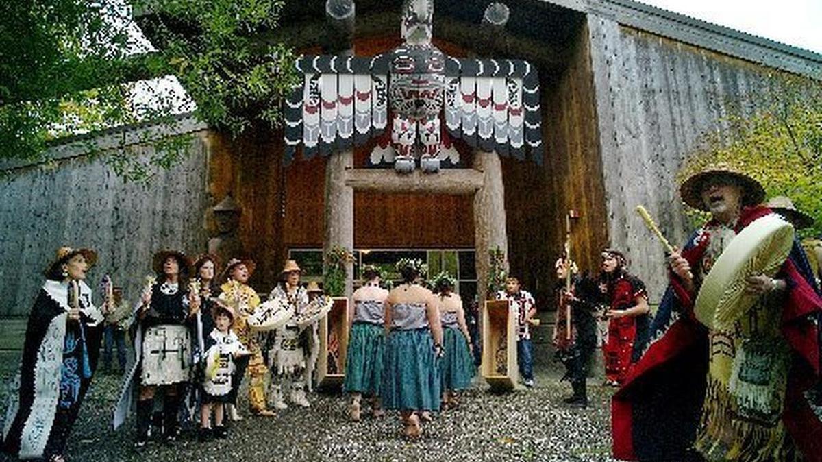 Accompanied by the sound of the processional song, participants make their way past a line of drummers for the Longhouse Education and Cultural Center at The Evergreen State College in November.
