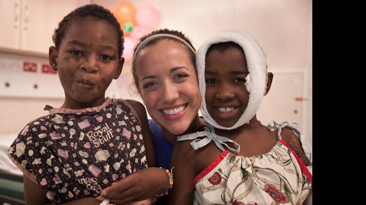 
Nurse and Olympia High School alumna Molly Gacetta plays with patients Mamy and Windy on the Mercy Ships hospital ship.
