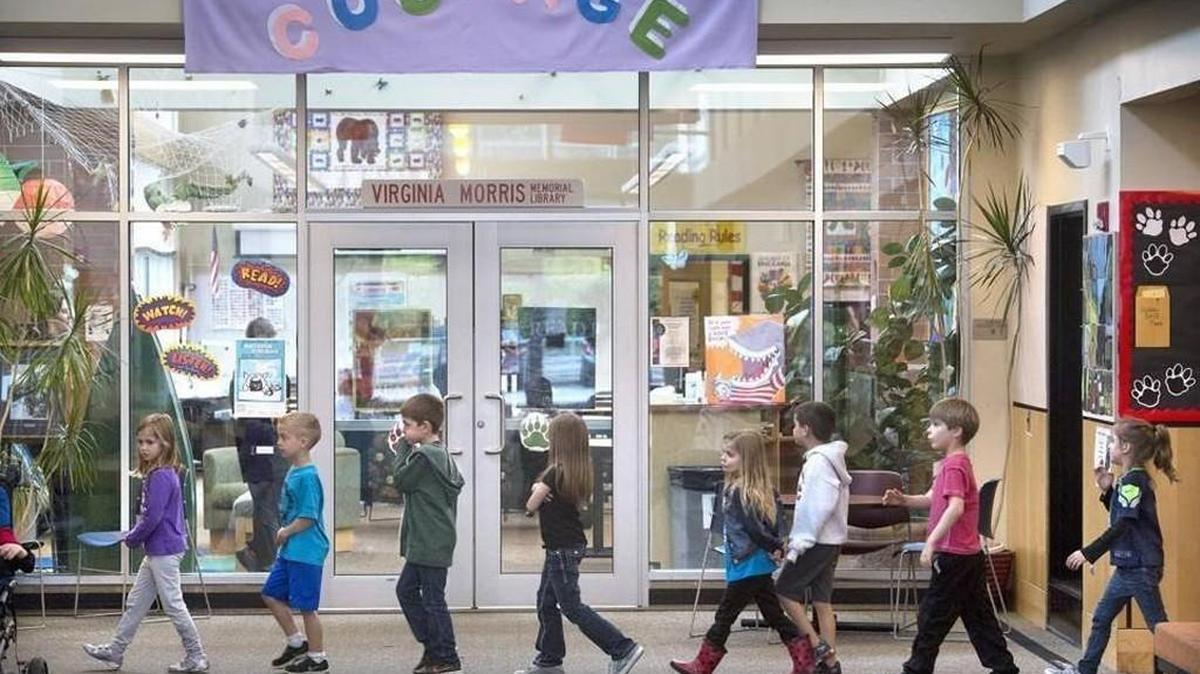 Students pass the Griffin School library as they walk through the main entry foyer. A requested levy to make safety improvements to the school, including a more secure entryway, was passing on Tuesday night.