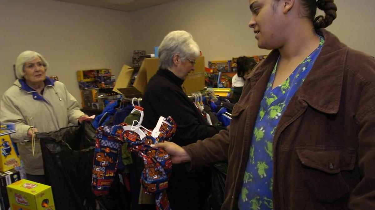 Shopping for her 3-year-old son, Crystal Green finds a colorful, two-piece suit with help from Phyllis Wilson, who has volunteered at the Salvation Army’s Toy and Joy Shop for 10 years.