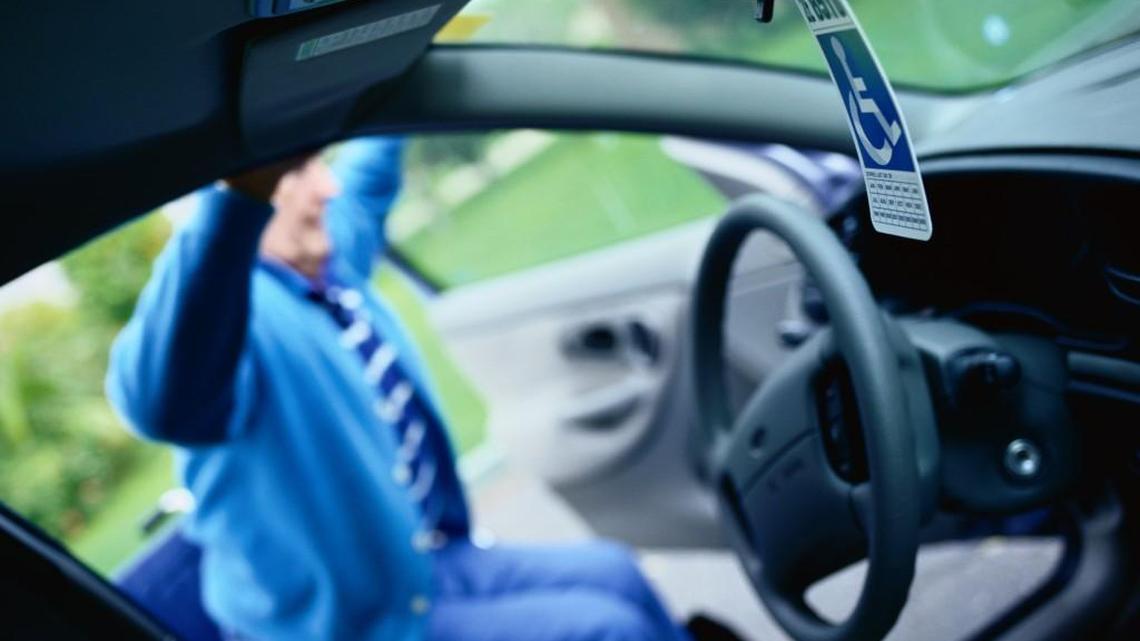 It’s legal to drive with a disabled-person parking placard hanging from the rear-view mirror, as long as the driver can see around it, police say.