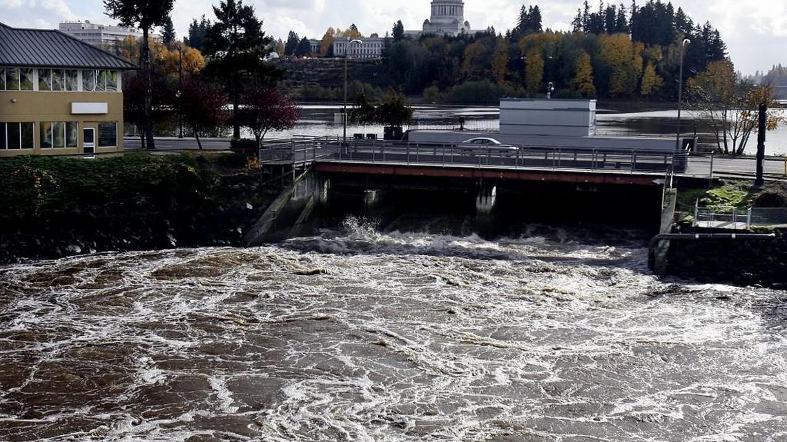Water rushes through the Fifth Avenue Dam into Budd Inlet after heavy rain in 2006. The dam will undergo repairs starting Dec. 26.