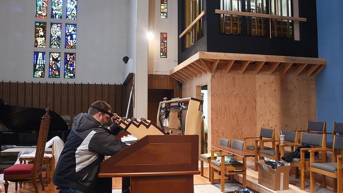Sean Haley from the Seattle-based Pipe Organ Builders Inc. works on the keyboard of the Hermann Schlicker pipe organ during its. installation at St. John’s Episcopal Church. The church will screen the silent film “Phantom of the Opera” on Halloween, with an improvised organ accompaniment.