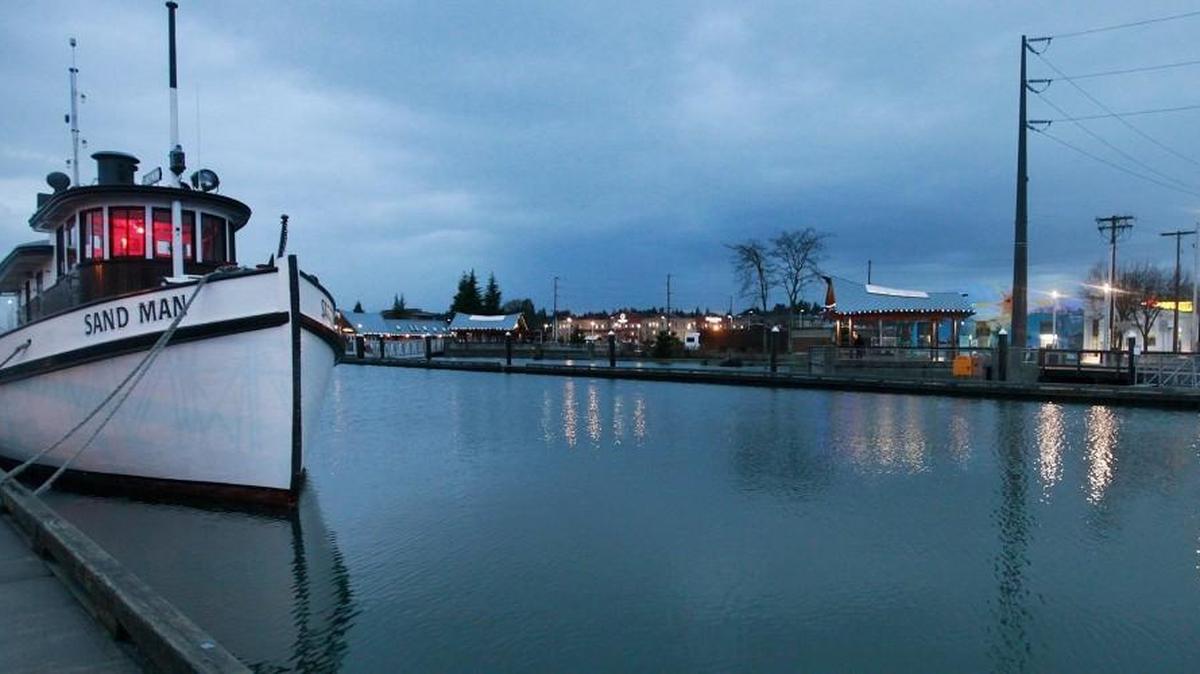 High tide at Percival Landing creeps close to the top of the boardwalk early Dec. 9, 2014, bringing floating docks and moored boats almost level with nearby streets.