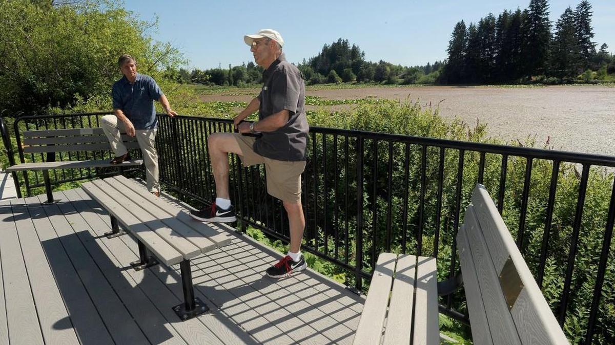 Lacey Rotary Club members Greg Cuoio, left, and Allen Johnson outline the organization’s project at the Chehalis-Western Trail overlook near Shincke Road. The Rotary Club built and donated the overlook.