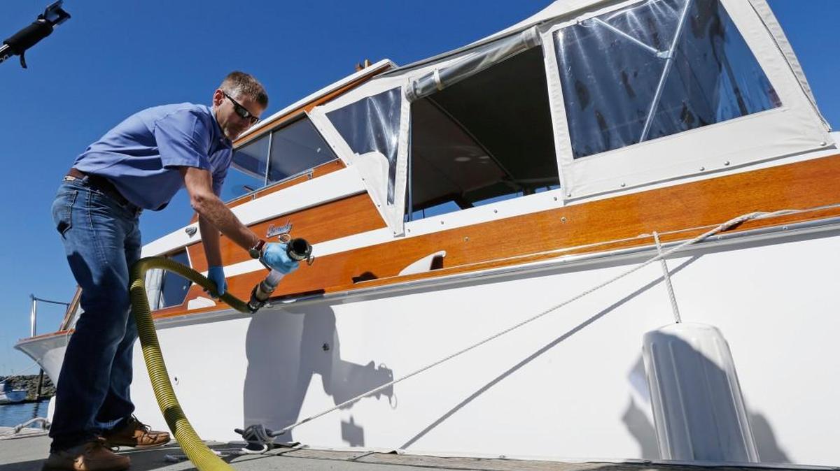 Todd Powell, of Federal Way, demonstrates to reporters how to pump out the sewage holding talk on his boat at a pump-out station at the Des Moines Marina, on July 21, 2016, in Des Moines. Puget Sound would no longer be a toilet for vessels dumping raw or partially treated sewage overboard under a regulation proposed by the state Department of Ecology.