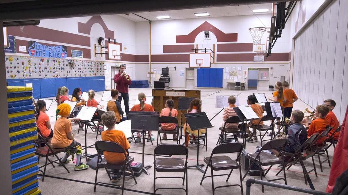 Band teacher Keith Holder (back left) leads fifth-graders during class in the gymnasium at Centennial Elementary in Olympia in 2015.