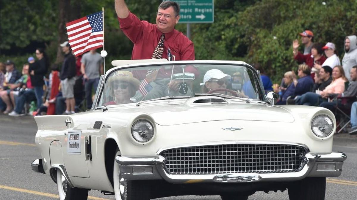 Tumwater Mayor Pete Kmet waves to a crowd of several thousand spectators who lined along Capitol Boulevard Monday during the annual Tumwater Independence Day Parade. Kmet has announced that he won’t seek re-election in 2021.