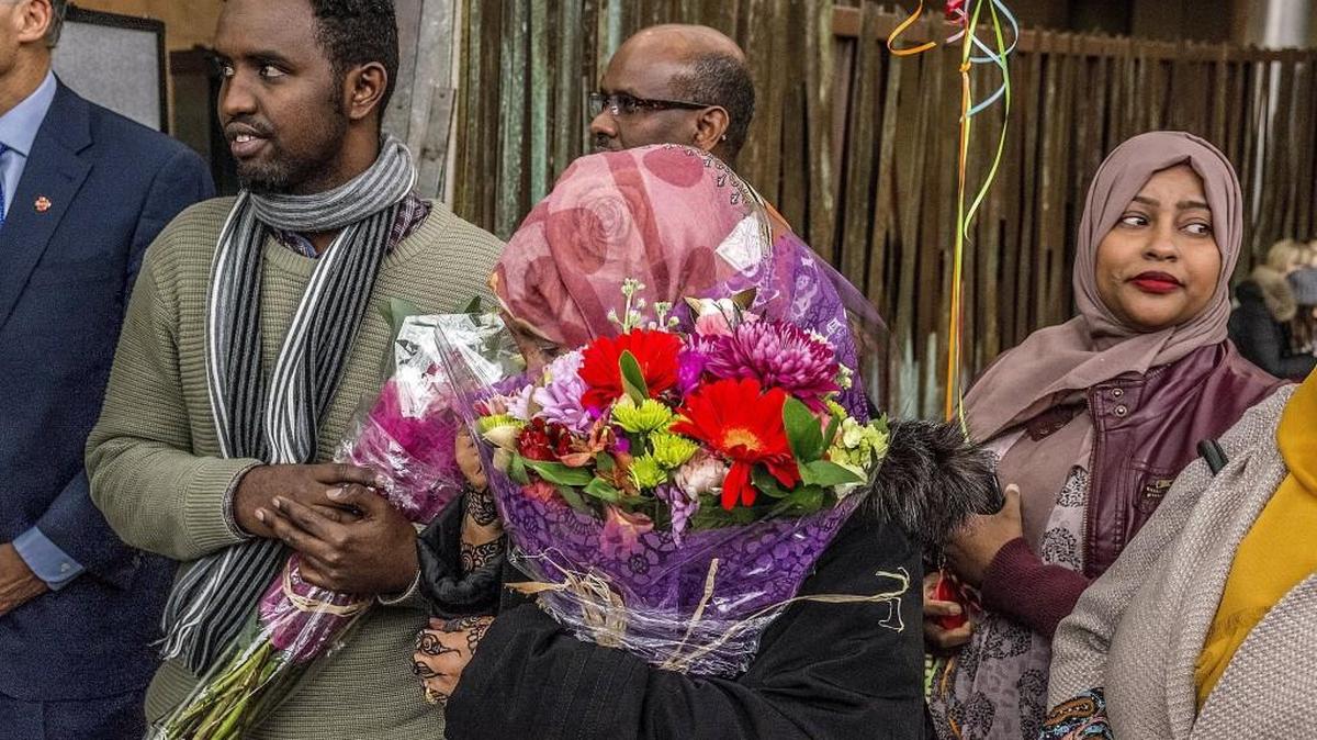 Isahaq Ahmed Rabi, left, arrives at Sea-Tac Airport from Vienna and is greeted by his wife Ibado Hassan, center. Rabi is an immigrant from Somalia, one of the countries included in President Donald Trump’s travel ban.