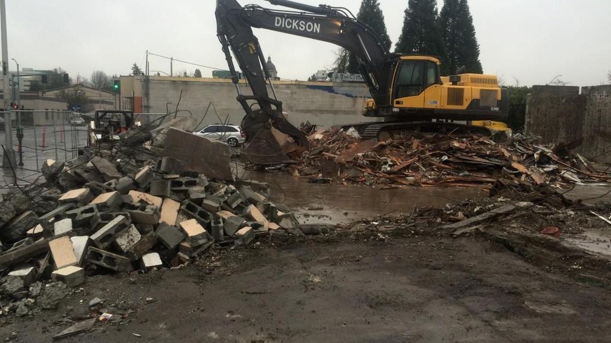 Crews from WM Dickson Company began the demolition this week for two city-owned buildings at Water Street and Fourth Avenue in downtown Olympia.