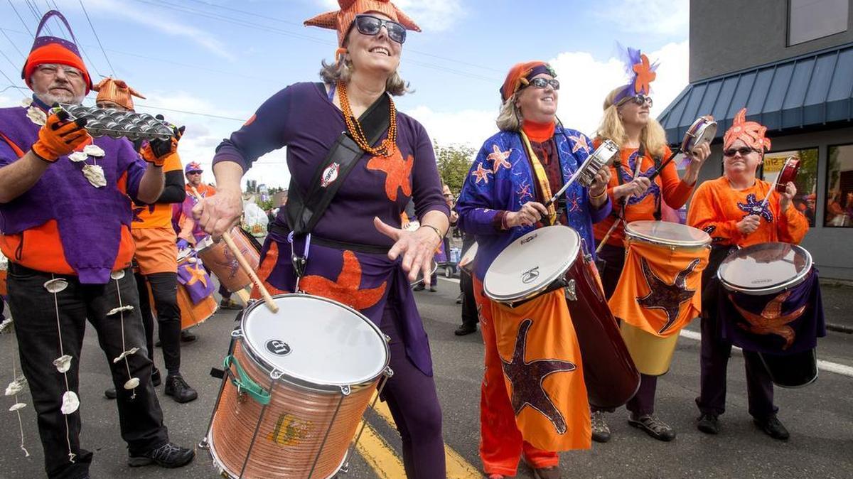 Dressed as a sea star with her fellow Samba Olywa members, Julie Kelen of Olympia bangs out a beat during last year’s parade. The Brazilian dance and drum group are longtime participants in Olympia’s Procession of the Species.