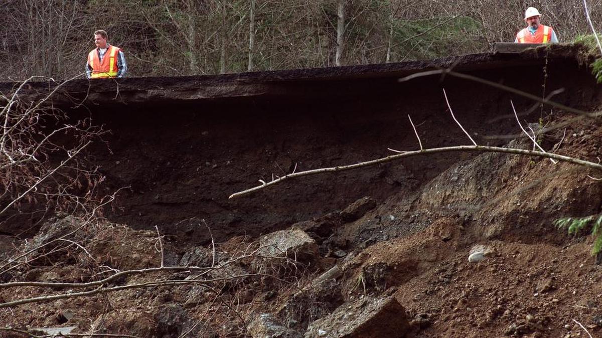 DOT officials look down to the landslide that occurred during the 2001 Nisqually earthquake.