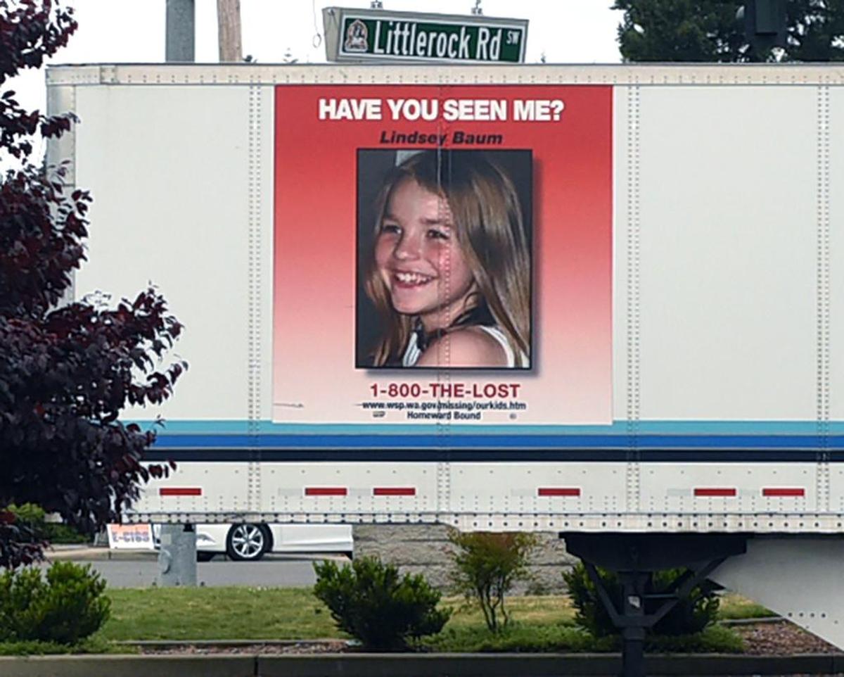A semi trailer displaying the photo of Lindsey Baum sits in a parking lot near the 5th annual Missing and Exploited Children's Day held at the Tumwater Walmart.