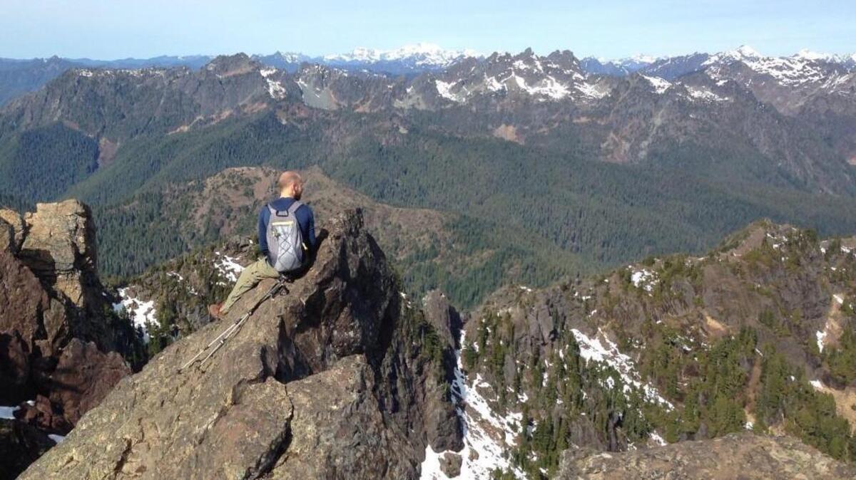 FILE PHOTO: A hiker takes in the barely snowcapped peaks of the Olympics from the top of Mount Ellinor. Sen. Patty Murray and Rep. Derek Kilmer have re-introduced the Wild Olympics Wilderness and Wild and Scenic Rivers Act to protect environmentally sensitive parts of the Olympic Peninsula.