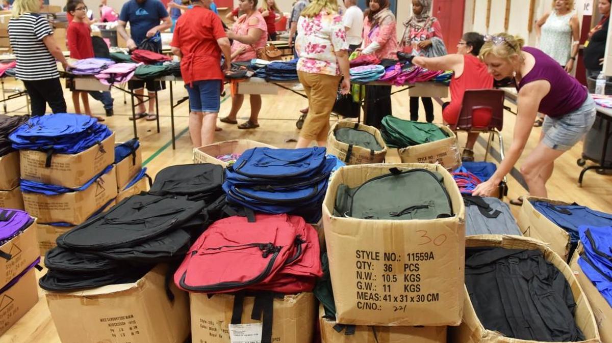 Rows of boxed new backpacks dwindle down as volunteers give them away to around 3,000 children during the Little Red Schoolhouse Project's free school supply distribution. Little Red Schoolhouse Radio Day dundraiser to send students “back to school with pride” is Aug. 11. Collecting school supplies, backpacks, new or clean, gently used coats, new socks and underwear, or money to purchase supplies. Come to Mixx 96.1 at the corner of State Avenue and Washington Street, Olympia, 6 a.m. to 6 p.m. Donations may also be mailed to Little Red Schoolhouse at PO Box 6302, Olympia, WA 98507. Information: www.redschool.org for more information.