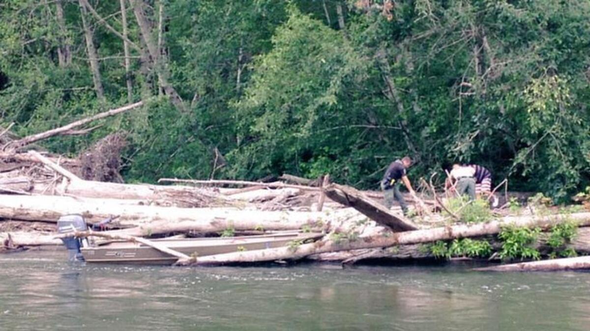 A man in his 40s is recovering from minor leg injuries after getting caught in a log jam while floating down a river on an air mattress.