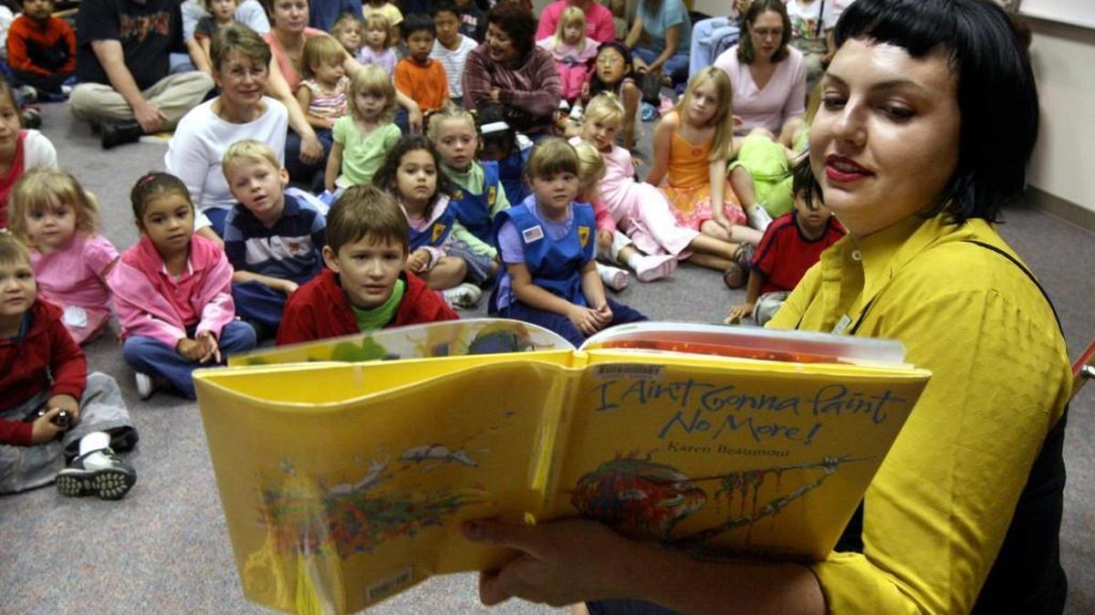 
In a 2007 photograph, library associate Kelsie Raddas reads the book “I Ain’t Gonna Paint No More!” to a crowd gathered at Pre-School Story Time at the Lacey Timberland Library.
