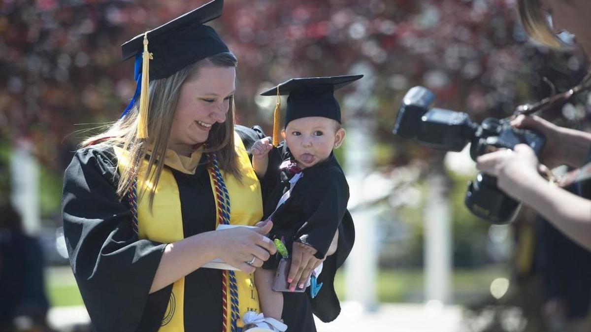 Saint Martin’s graduate Tamara Bellisle of Shelton laughs as her daughter, MaLeah, 5 months, sticks out her tongue while getting a photo taken before commencement ceremonies at Saint Martin’s University in Lacey on Saturday. Bellisle earned a bachelor’s degree in social work.