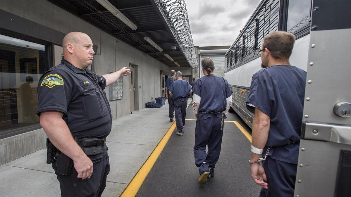 
Brian Boman, a corrections deputy with the Thurston County Sheriff's Office, directs inmates to the transfer area of the new Accountability and Restitution Center (ARC) in Tumwater on Saturday Approximately 350 inmates were transferred in high-security busses from the old Thurston County Jail in Olympia.
