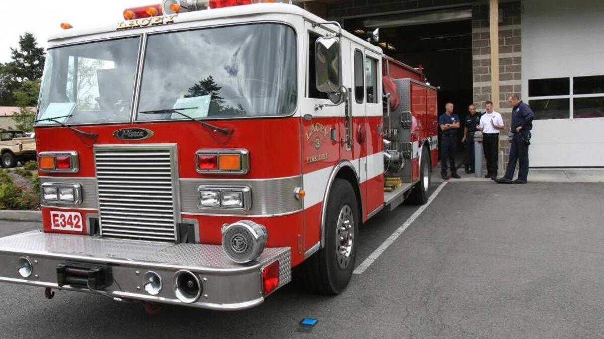 Lacey Fire Chief Steve Brooks, center, talks with firefighters at the Mullen Road station. Lacey Fire and the Nisqually Tribe have come to an agreement on how much the tribe should pay to be served by the Fire Department.
