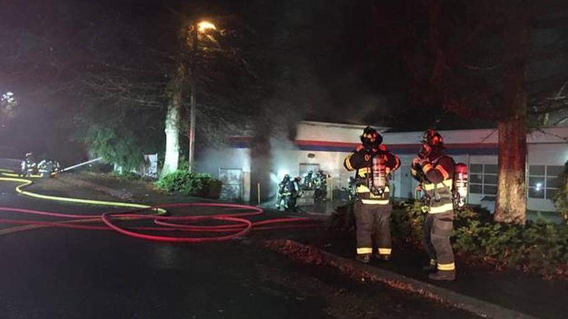 Firefighters respond to Firestone Complete Auto Care on Harrison Avenue Northwest early Wednesday.