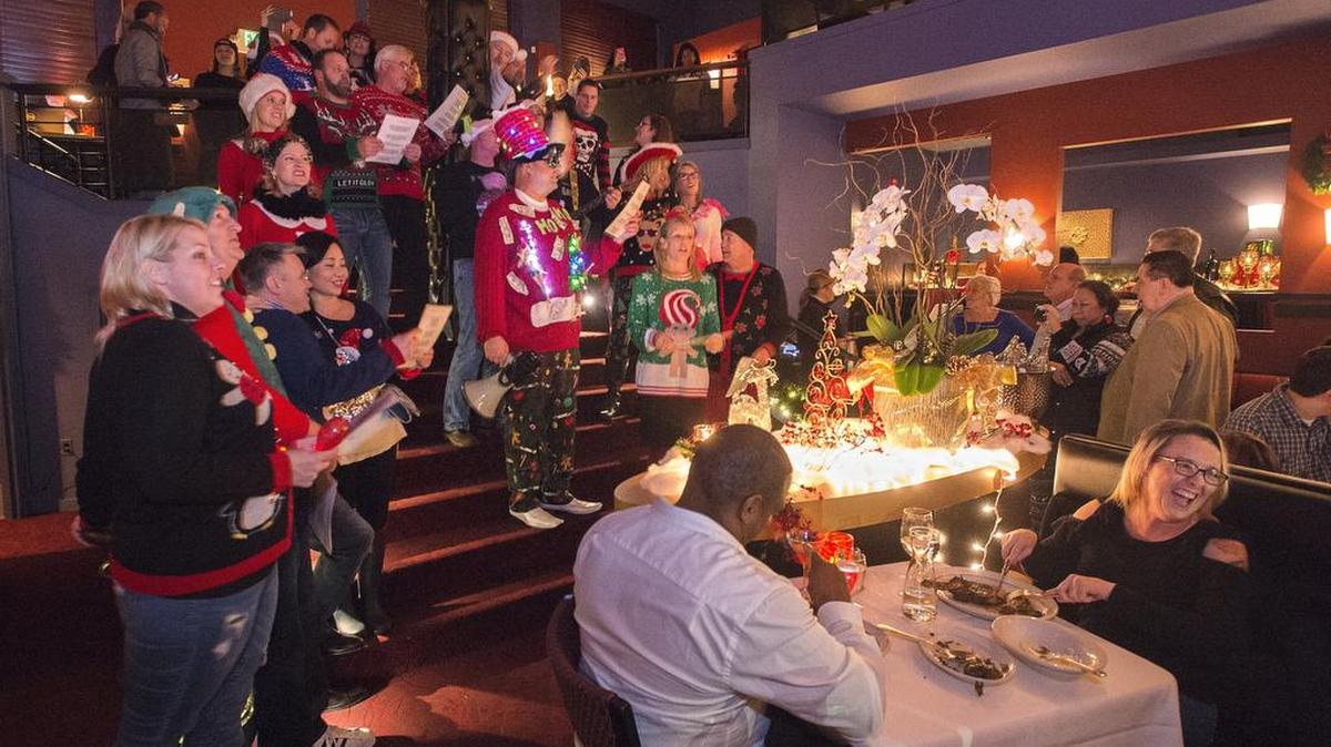 Proof that holiday cheer doesn’t need an official invitation. Diners at El Gaucho laugh as an ugly Christmas sweater-wearing flash mob sings carols after busting through the front door.