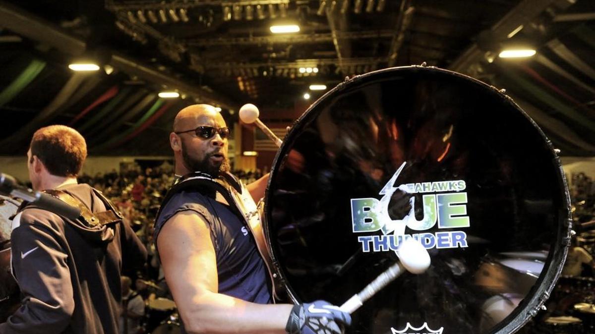 Navfe Terry, right, and Nic Crocker, left, perform on tonal bass drums along with other members of the Seattle Seahawks Blue Thunder Drumline in Tacoma.