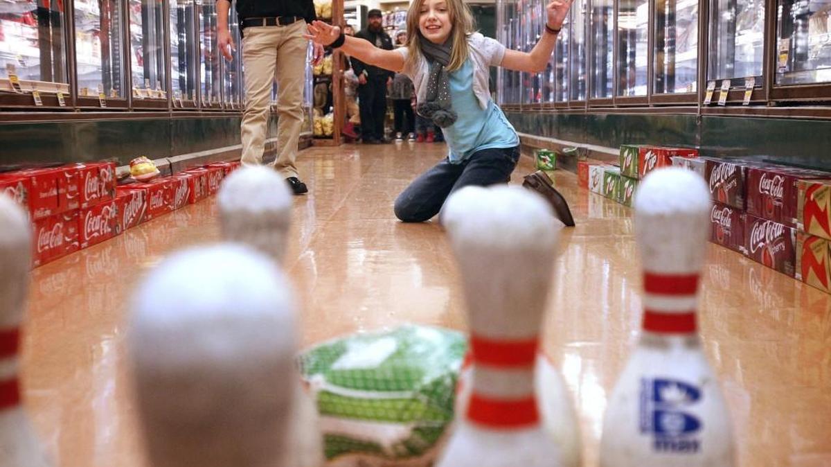 Ceilidh Ranger, 10, lets the frozen turkey fly as she takes her turn at the annual Turkey Bowl giveaway at Bayview Thriftway in downtown Olympia in 2014. Bayview Thriftway is again hosting its Frozen Turkey Bowl from 11 a.m. to 1 p.m. Saturday.