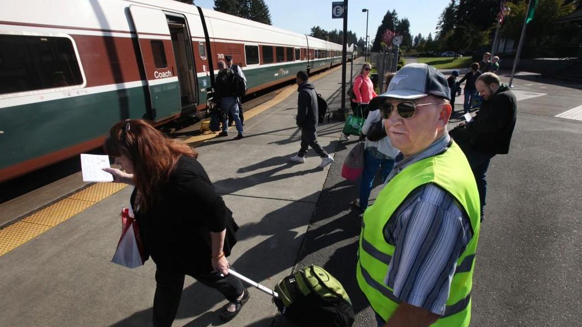 After opening the boarding gate Centennial Station volunteer Jon Cox watches as passengers board the 10:20 am Amtrak southbound train Thursday.The depot will be celebrating its 20th year off of Yelm Highway this Saturday.