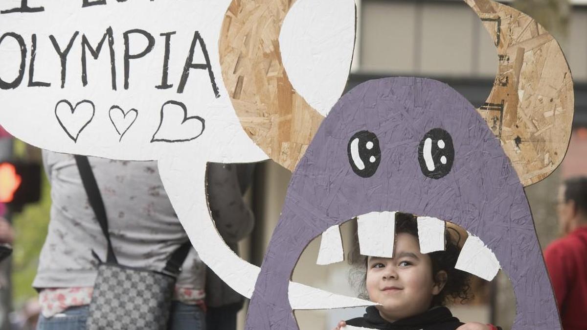 Aaliyah Watson, 3, peeks from a monster cutout on display outside of Captain Little toy store during Spring ArtsWalk in downtown Olympia on Friday. Aaliyah is the daughter of Daniel and Emma Watson of Olympia.