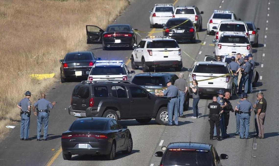 Law enforcement gather at the scene where a Washington State Patrol trooper fatally shot a driver stopped on southbound Interstate 5 near the Carpenter Road overpass in Lacey on July 8. An independent investigation by a regional law enforcement group and the Thurston County Prosecutor’s Office has determined the shooting was justified.