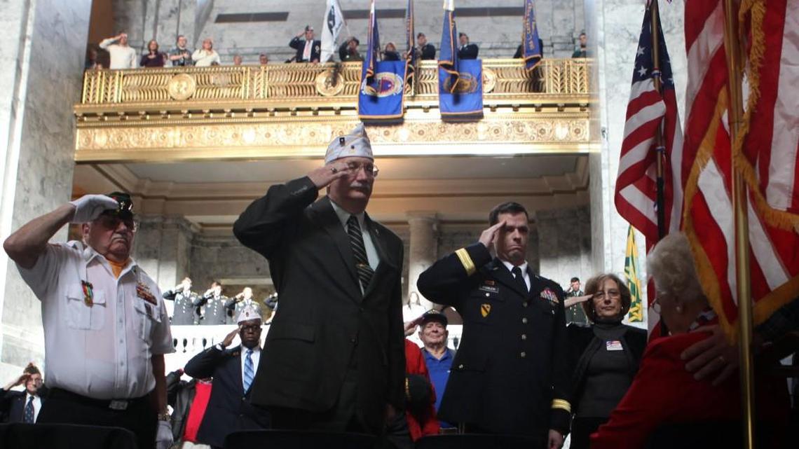Chaplain RD Norleen, American Legion Area 11 Vice Commander Dave Hodgeboom, Washington Army National Guard Brig. Gen. Chris Fowler and Thurston County Veterans Council chair Lou McElroy (left-right) salute during the closing playing of Taps at the annual Veterans Day Ceremony at the Capitol Rotunda in 2013.