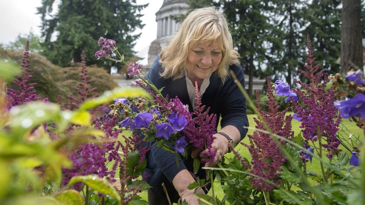 Washington State first lady Trudi Inslee works in her flower garden at the Governor's Mansion in 2014.