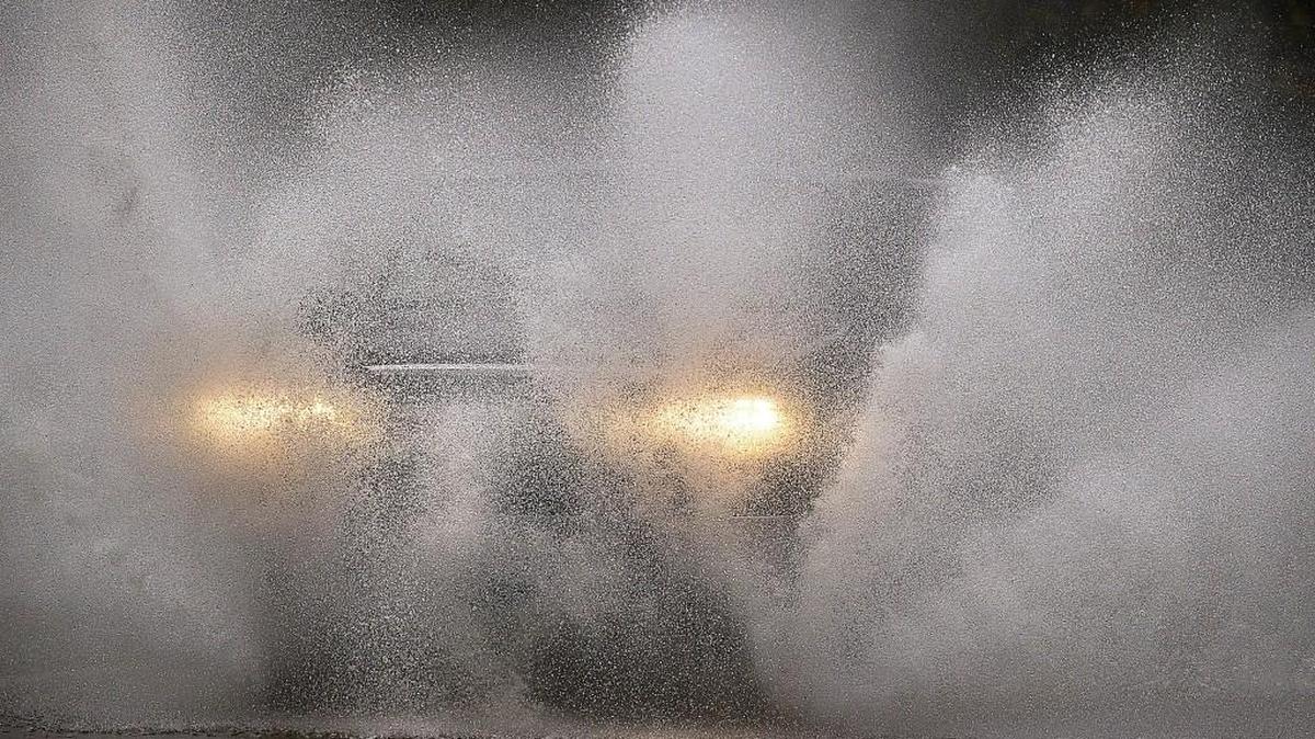 A truck blasts through floodwater on Case Road north of Grand Mound on Saturday, Nov. 14, 2015.