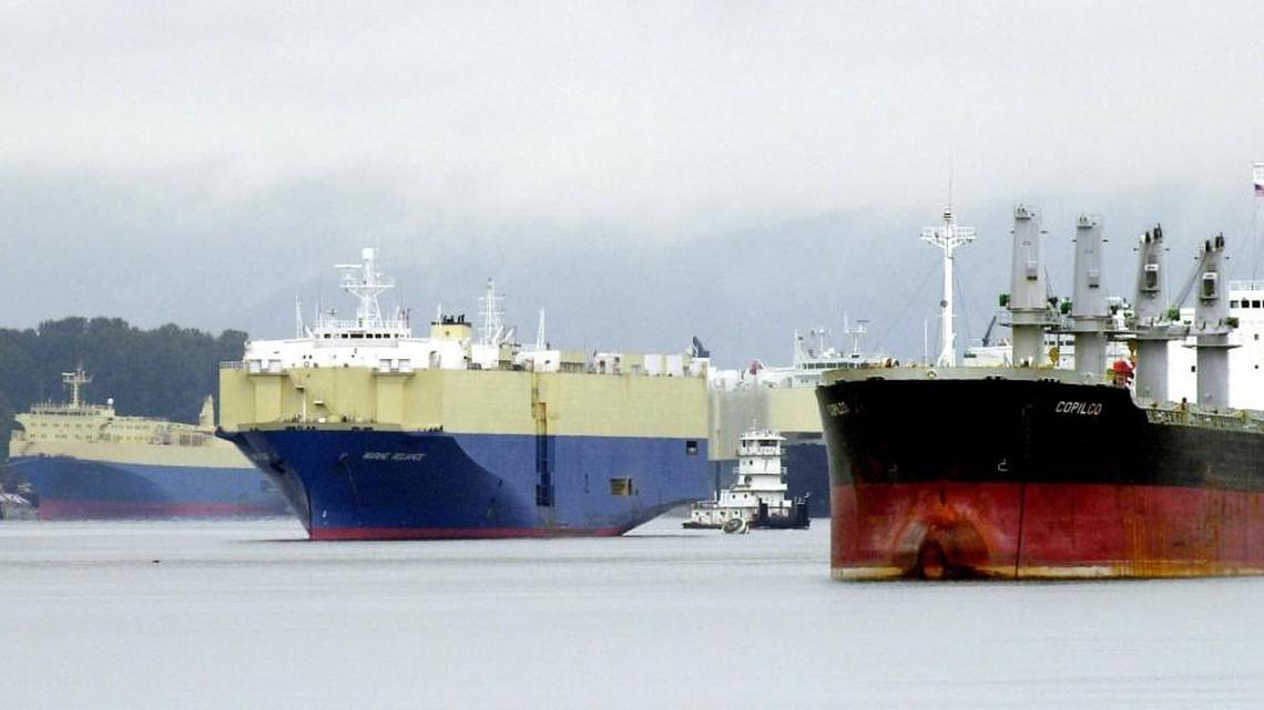 A tugboat maneuvering through waiting freighters on the Columbia River near the Port of Vancouver in Vancouver, Washington. Developers of a proposed oil-by-rail terminal along the Columbia River that would be the nation's largest poured big money into a local port commissioner race that may shape the project's future. Two Democratic state lawmakers plan to introduce a bill in January that would cap campaign donations for port races.