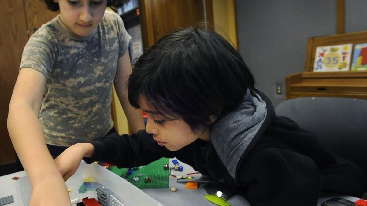 Addison Joshi Felizola,10, teams up with seven year-old August Ackley-Speights (right) as they design and construct a factory model at the March 2nd Lego Challenge workshop offered at the Olympia Timberland Library.