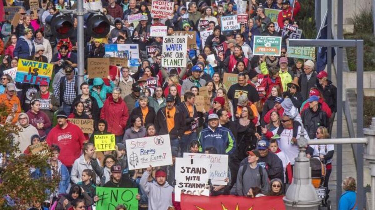 More than 1,000 people marched Saturday toward the center of University of Washington Tacoma campus to protest the expansion of fossil fuel projects. Several Western Washington tribes came to the march to support Indian-led efforts in the Dakotas to stop the construction of an oil pipeline.