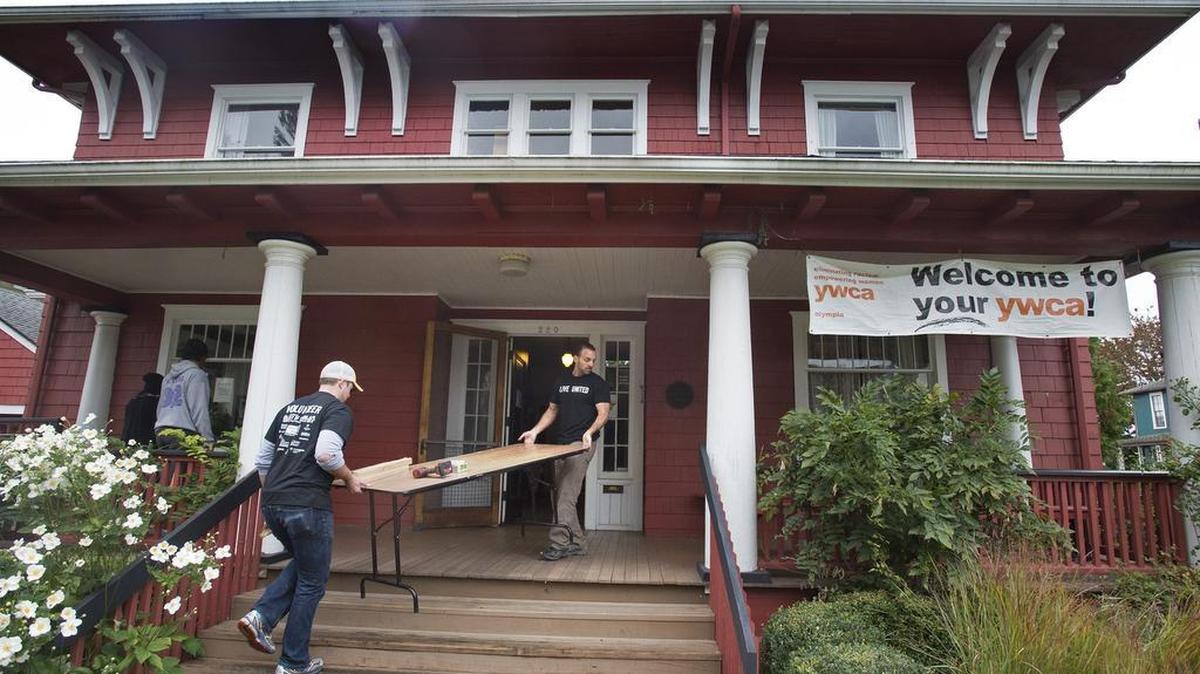 Casey Meehan (left) an independent health insurance broker from Lacey, helps Vernon Bonfield, owner of the Washington Independent Health Insurance Agency, work on repairs to the YWCA.