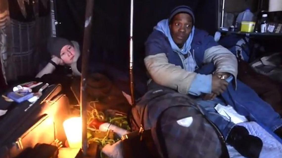 Phillip “Cricket” Jenkins, right, and another homeless resident are pictured Feb. 27 in a small shelter he built behind the New Moon Cafe on Olympia Federal Savings property. He was later evicted and the shelter was removed.