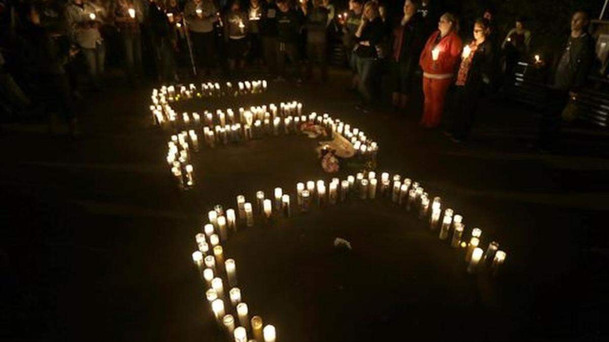 Candles spelling UCC for Umpqua Community College, are displayed at a candle light vigil for those killed during a fatal shooting at the school, Thursday, Oct. 1, 2015, in Roseburg, Ore. (AP Photo/Rich Pedroncelli)