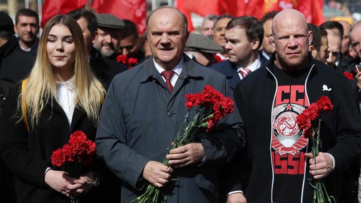From left, Russian powerlifter Maryana Naumova, Russian Communist Party Leader Gennady Zyuganov and mixed martial artist Jeff Monson attend a flower laying ceremony April 22 at Vladimir Lenin’s Mausoleum in Red Square on the 146th anniversary of the Russian revolutionary’s birth.